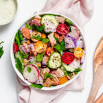 Salad with tomatoes, cucumbers, radishes and pita chips and an herb dressing