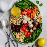 Niçoise salad platter with string beans, white beans, cherry tomatoes, olives, potatoes and lemon vinaigrette.