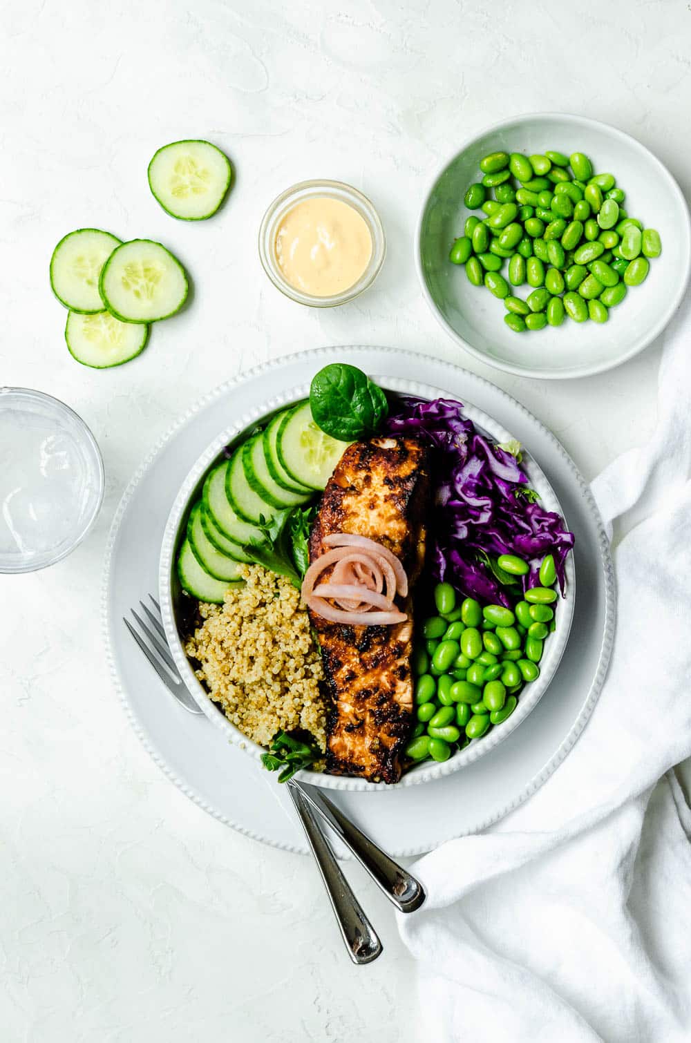 Asian Salmon bowl with quinoa, kimchi, cucumber and red cabbage