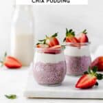 Two small jars of overnight strawberry chia pudding, topped with coconut yogurt and garnished with strawberries