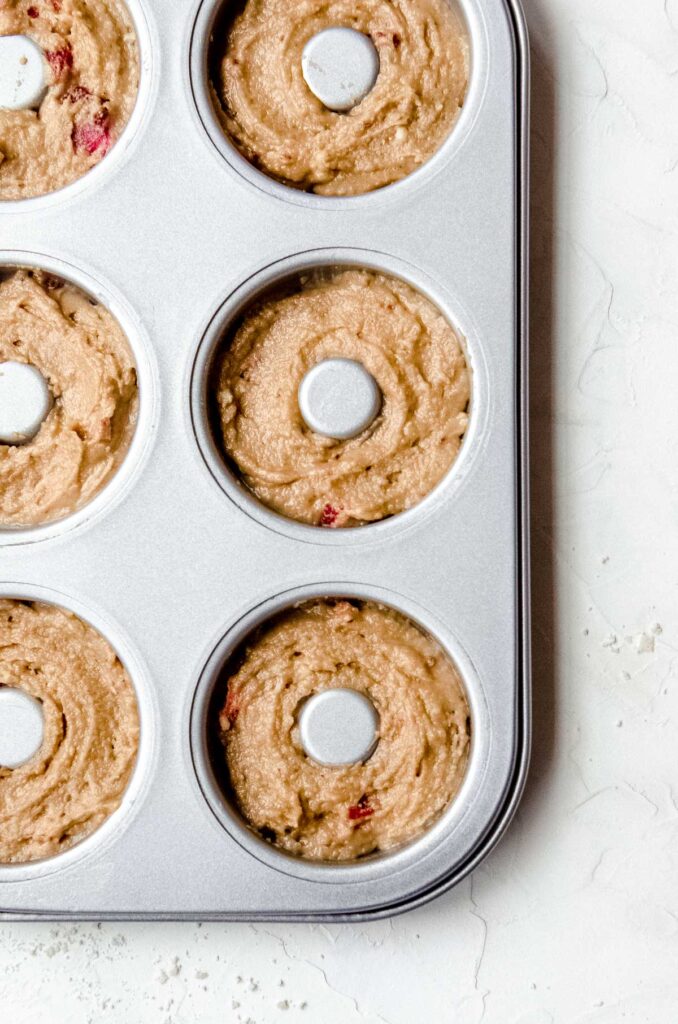 Batter for strawberry baked donuts in a donut pan.