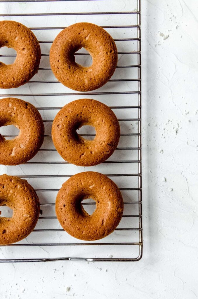 Six Strawberry Baked Donuts on a Cooling Rack