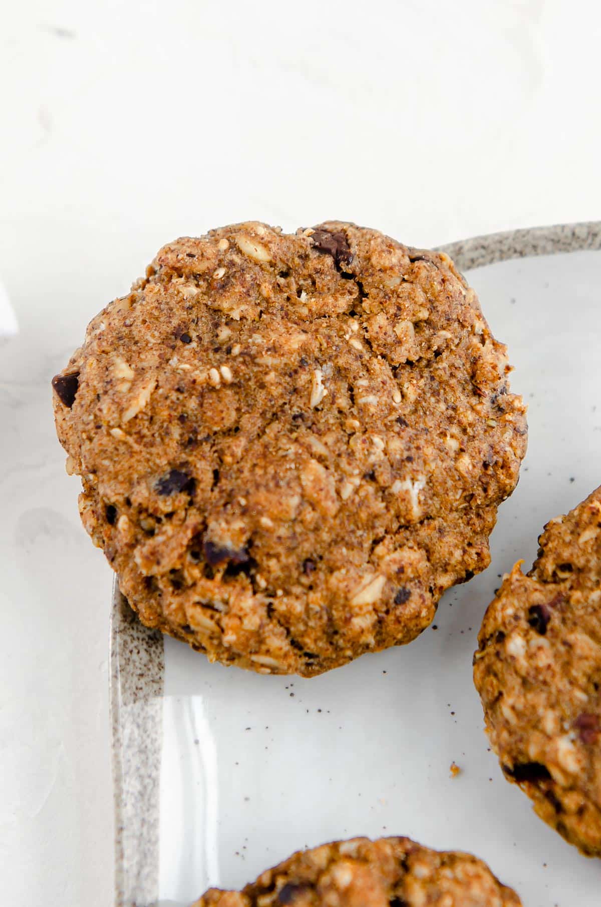 Close up of a banana oatmeal breakfast cookie with cacao nibs.