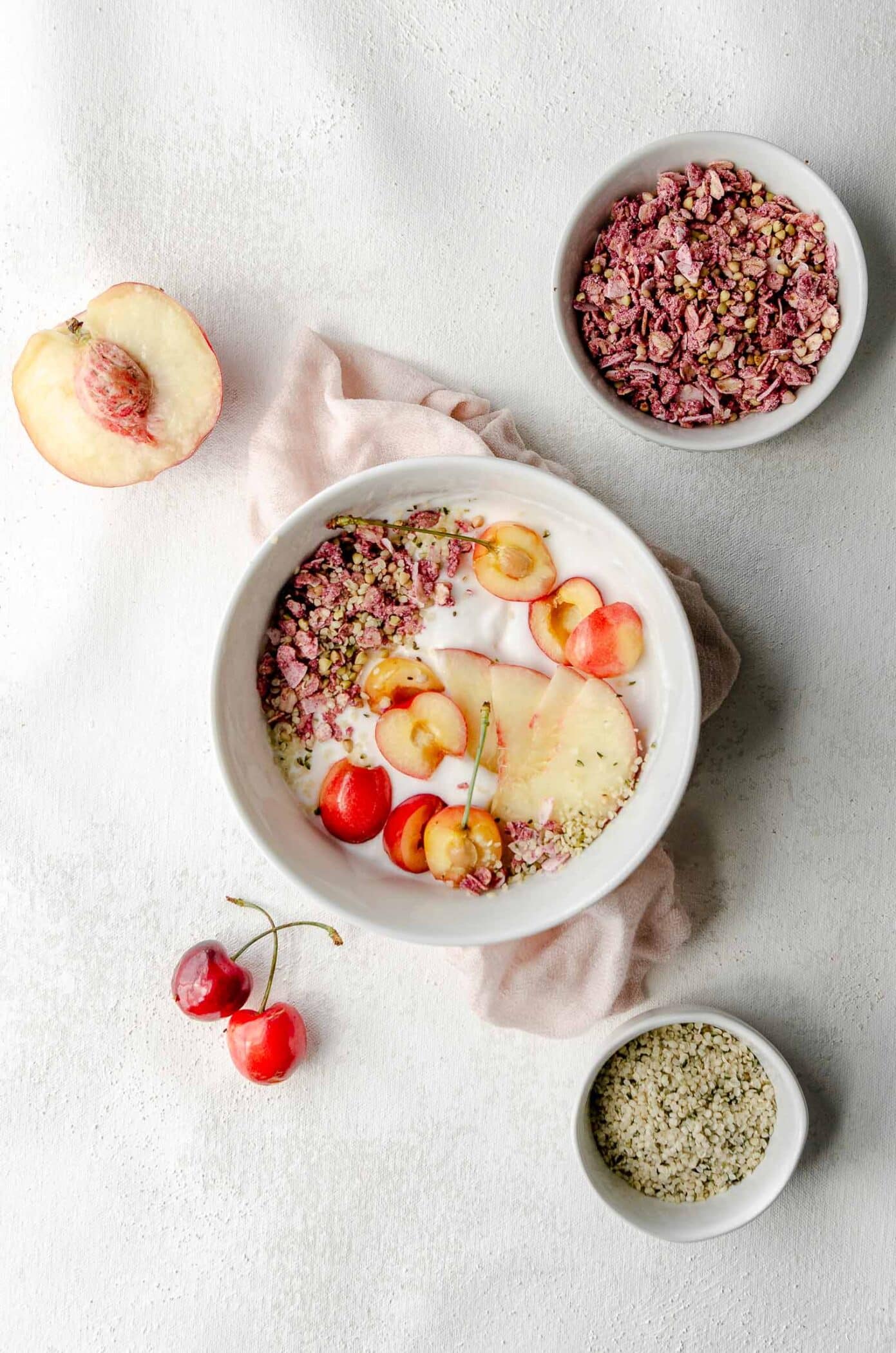 A bowl of coconut yogurt which is rich in probiotics made with cherries, granola and hemp seed