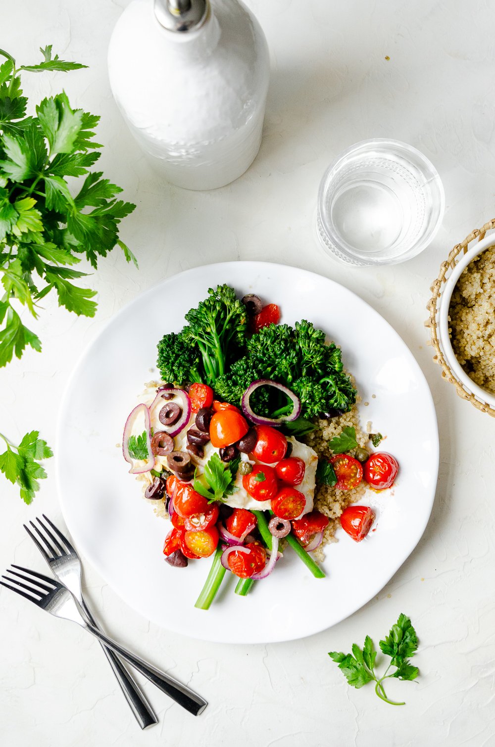 Baked halibut topped with cherry tomatoes, olives, onions, capers and parsley. Served over broccoli and quinoa. 